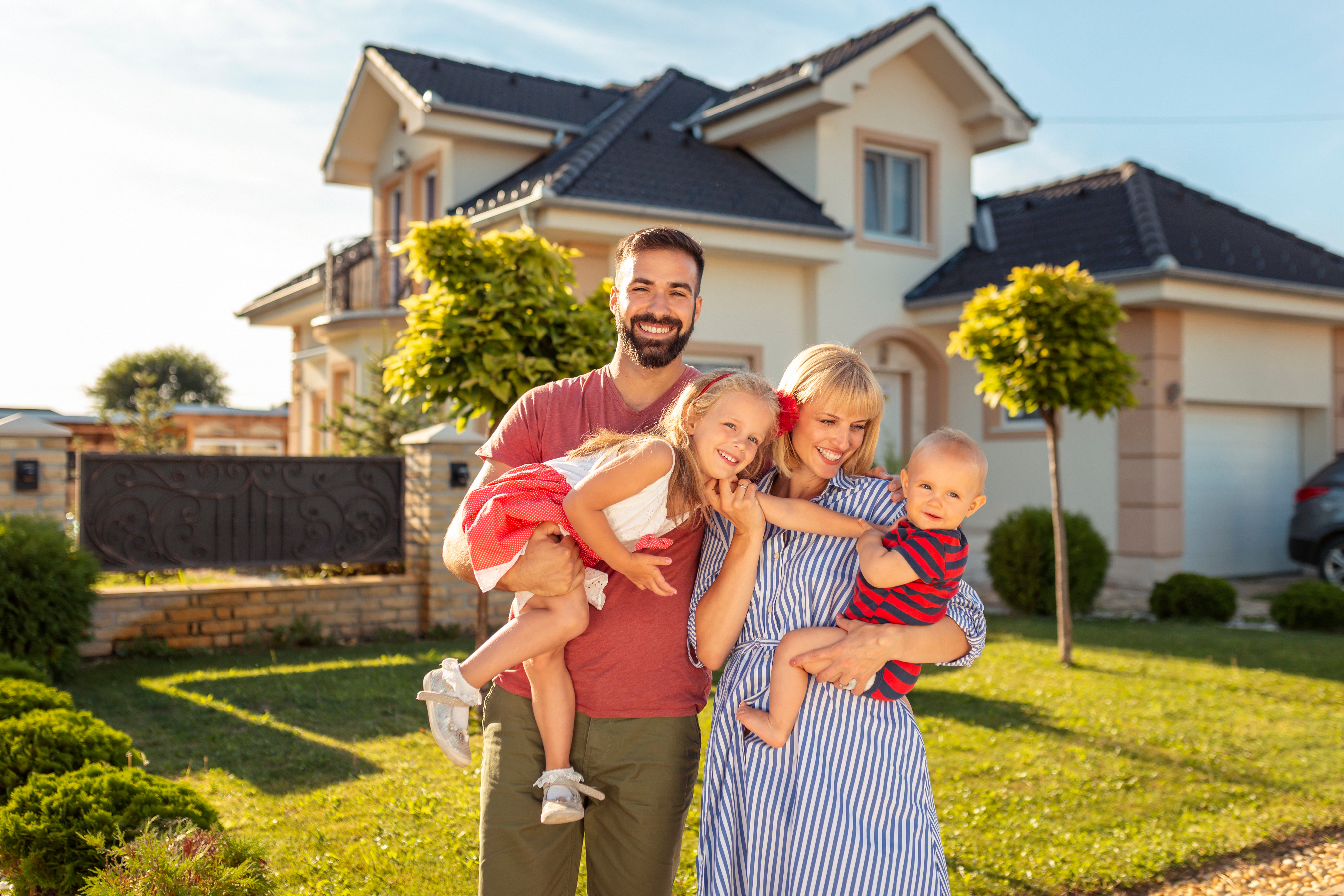 Family happy in front of their home